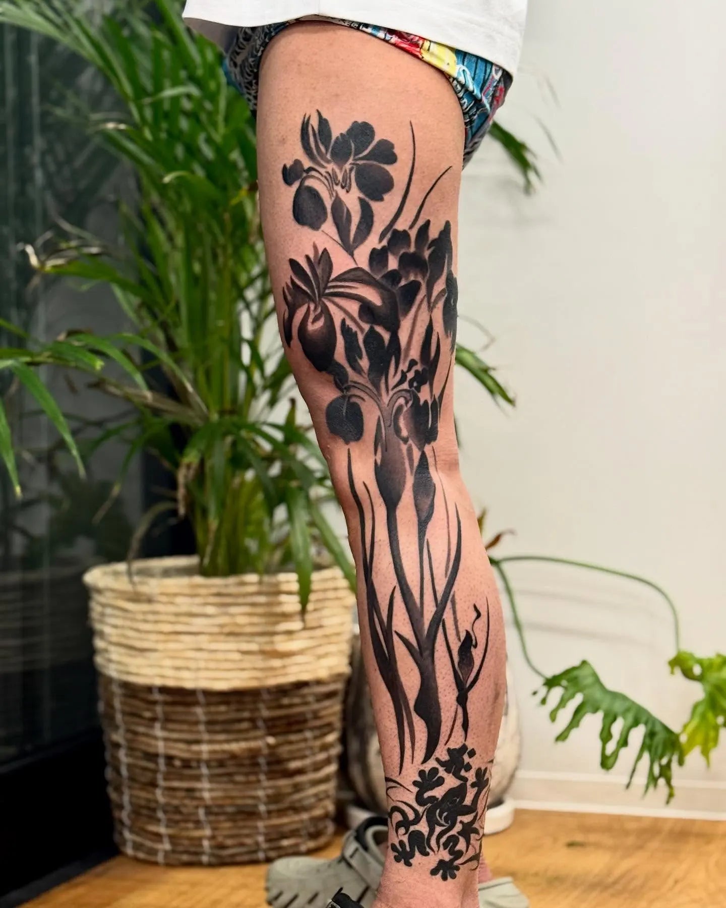 japanese black floral tattoo on man full leg sleeve