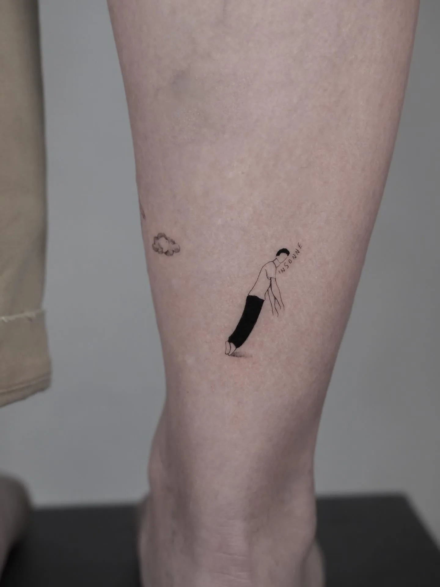 abstract illustrative minimalist little man tattoo on ankle
