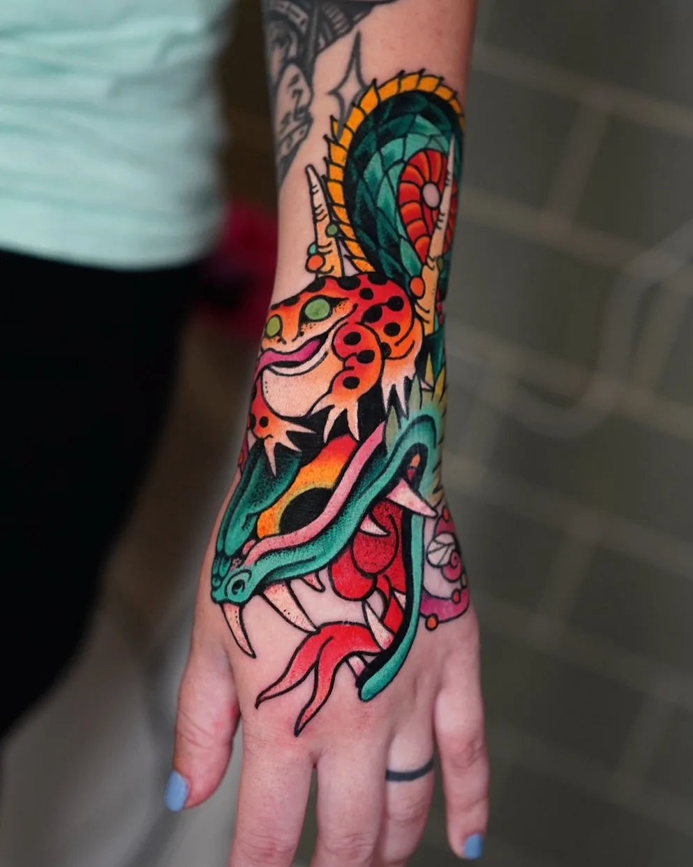 neo traditional frog and dragon tattoo on hand