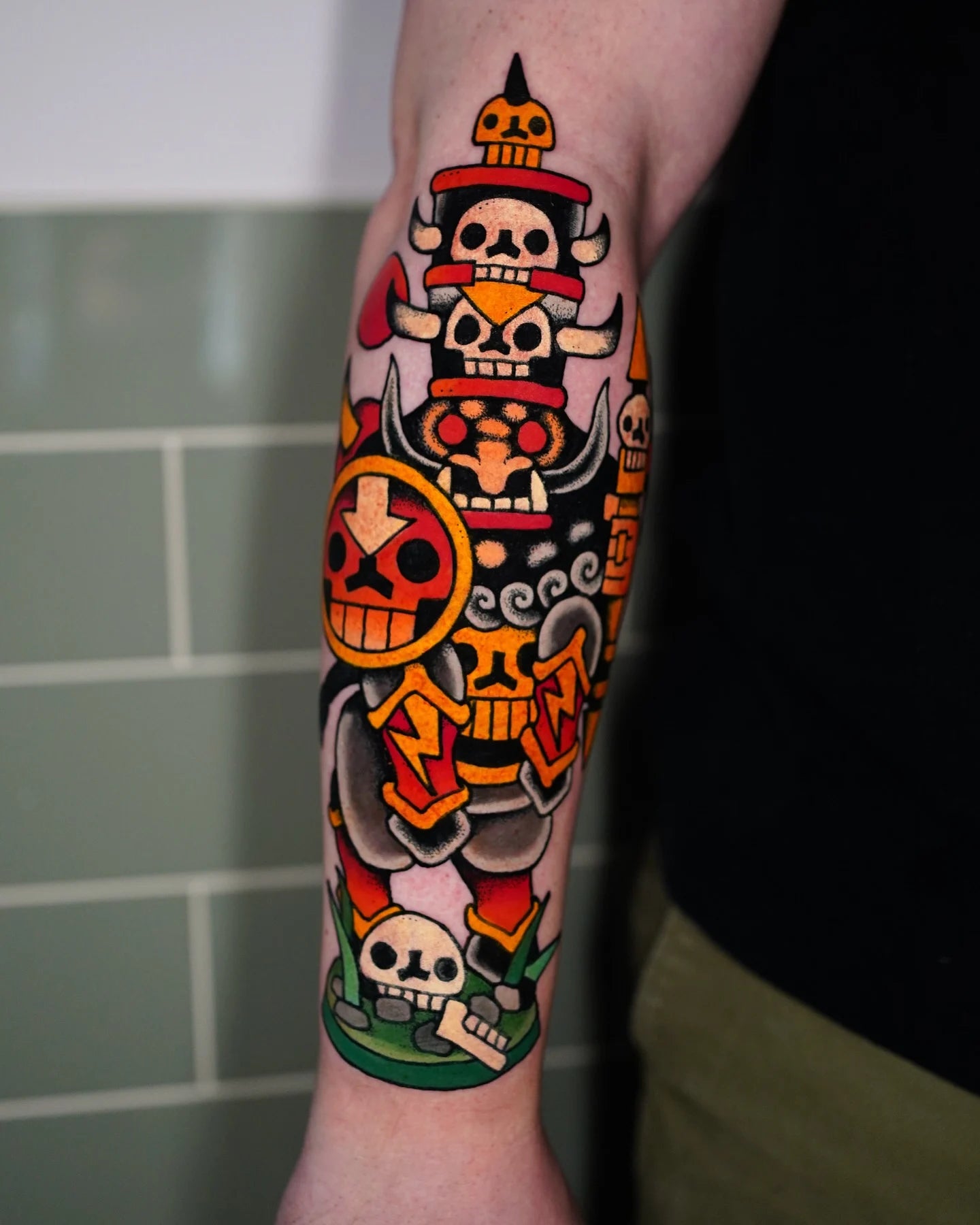 neo traditional cartoon skulls tattoo on man forearm