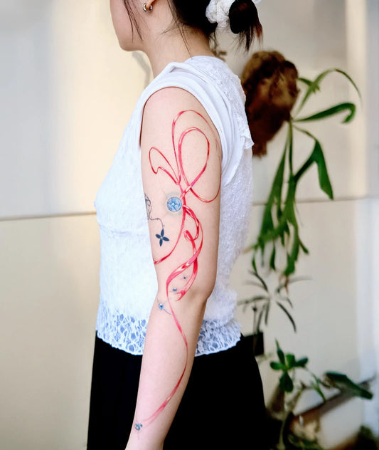abstract red ribbon woman arm sleeve tattoo