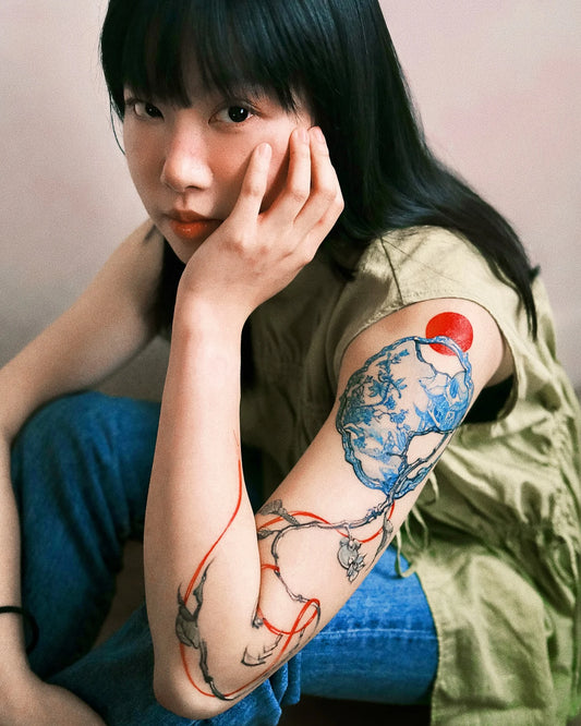 abstract watercolor woman arm tattoo