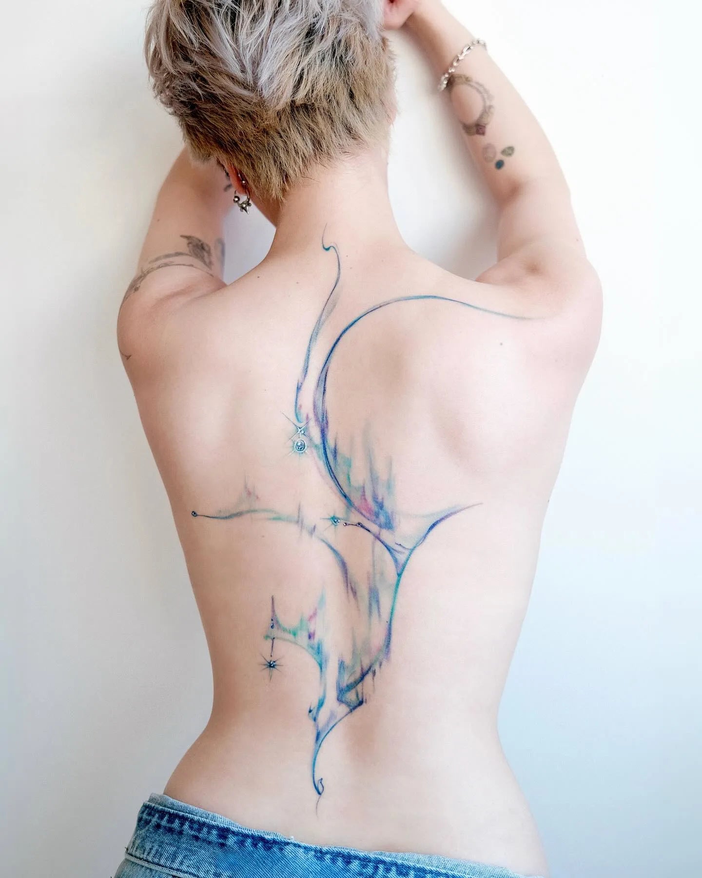 abstract blue watercolor full back woman tattoo