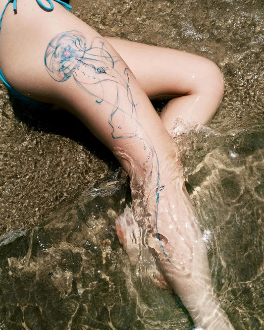 blue jellyfish thigh leg tattoo