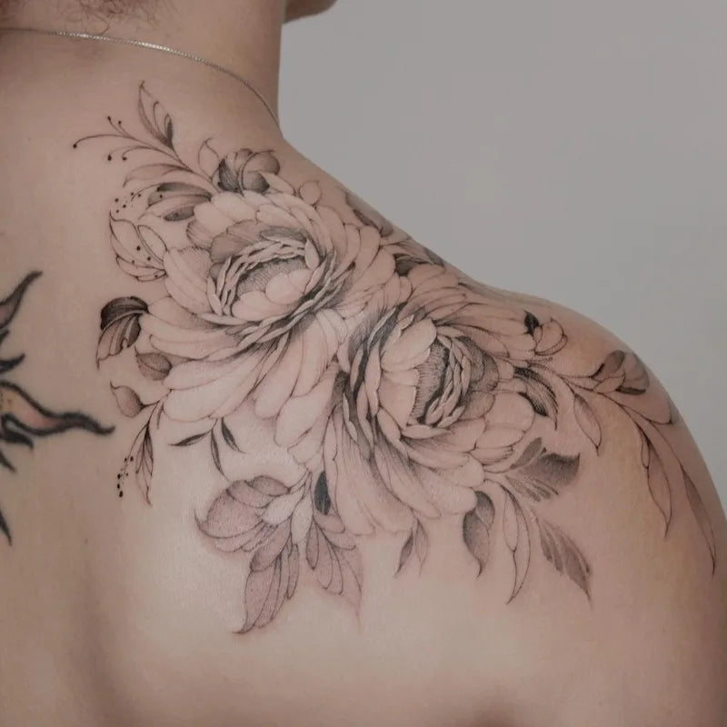 black and grey peony flowers tattoo on woman shoulder