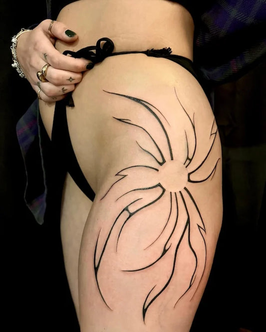 blackwork black lines abstract sunburst tattoo on woman hip thigh