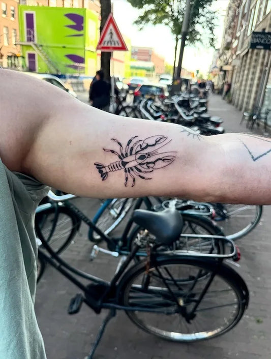 blackwork scorpion tattoo on man bicep