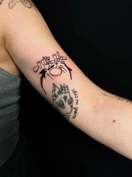 blackwork tableware glasses outline tattoo on woman bicep