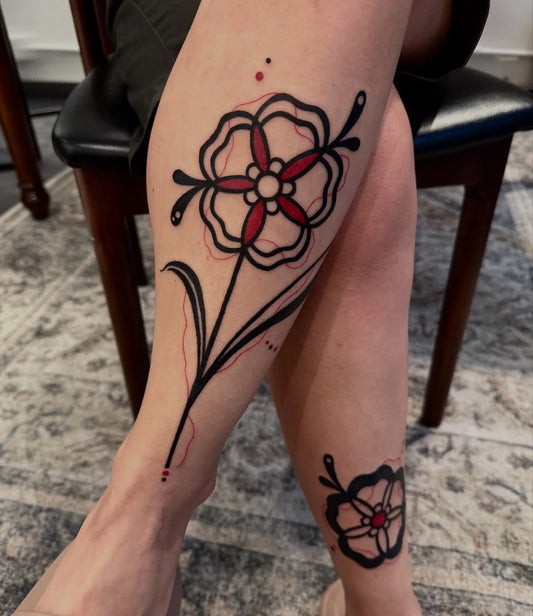 blackwork fine line flower leg tattoo