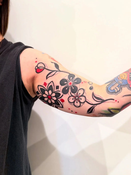 red balckwork fine line half sleeve tattoo