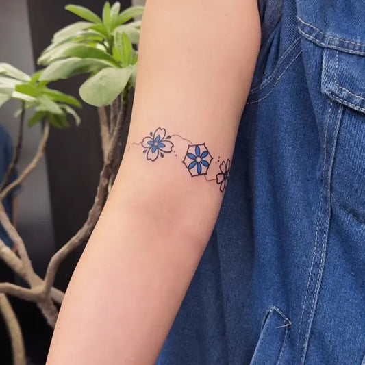 blue flower arm wrap tattoo