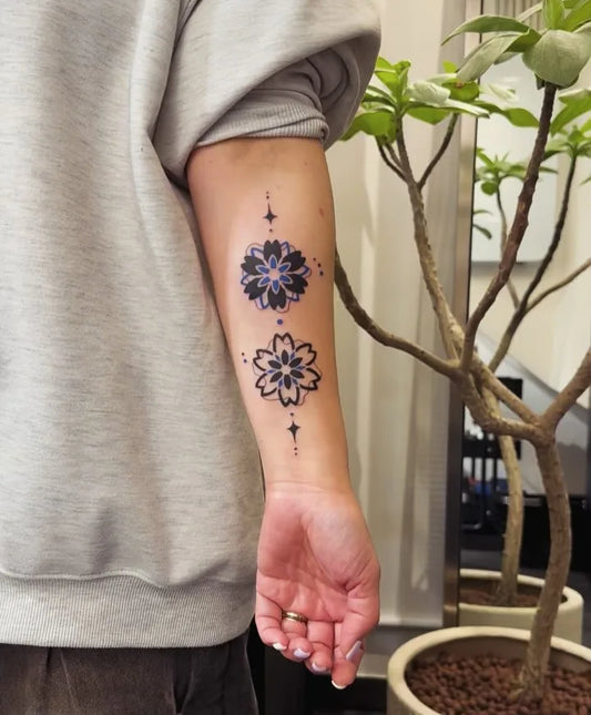 blue blackwork fine line flower forearm tattoo