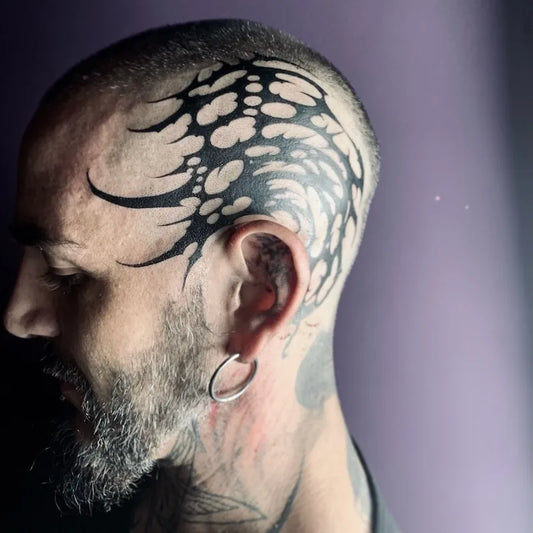 blackwork tribal pattern tattoo on man head