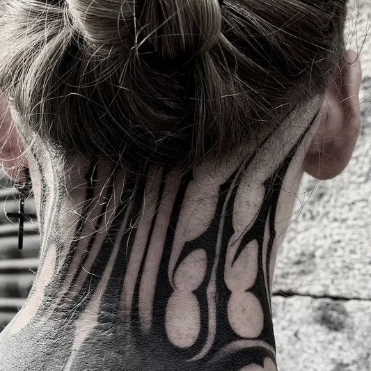 blackwork pattern tattoo on woman neck back