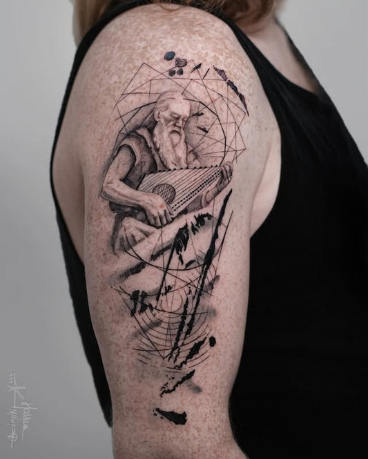 tattoo of a man playing a lyre with geometric designs on woman upper arm