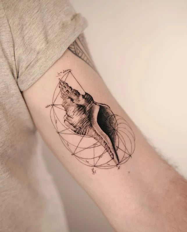 black and grey geometric shell tattoo on bicep