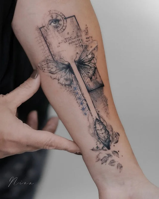 watercolor abstract butterfly with viking eye and feather tattoo on woman forearm