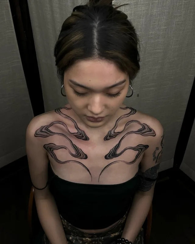 abstract black lines blackwork tattoo on woman shoulder