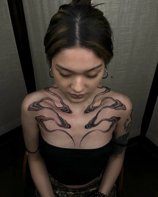 abstract black lines blackwork tattoo on woman shoulder