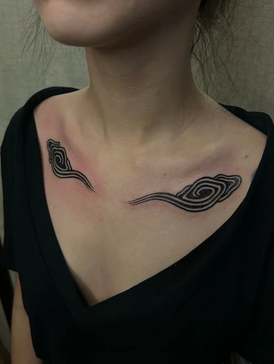 blackwork japanese cloud pair tattoo on woman collarbone