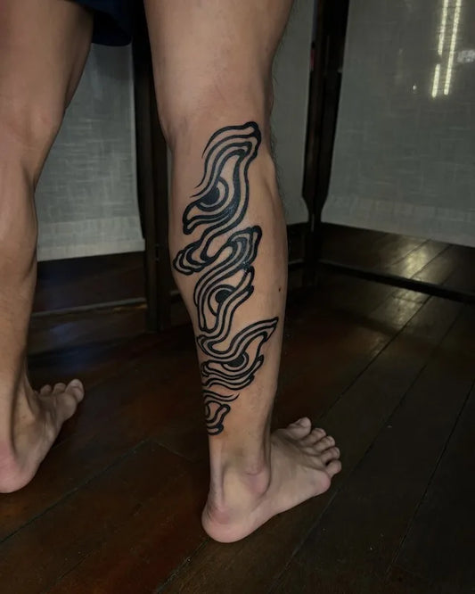 blackwork japanese eyes tattoo on man calf leg