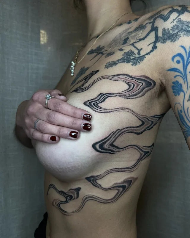 blackwork abstract lines tattoo around woman breast and rib