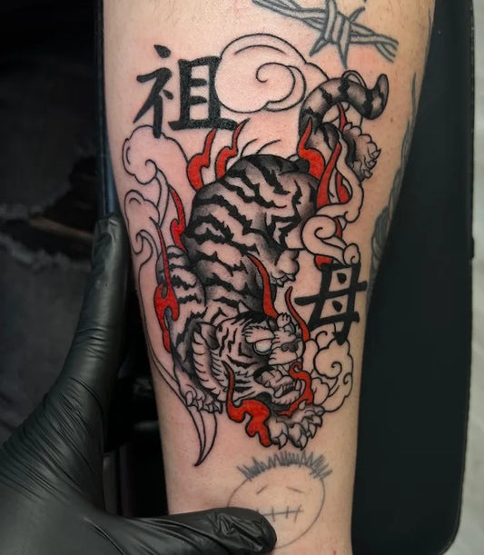 Japanese style stripped tiger with red accents tattoo