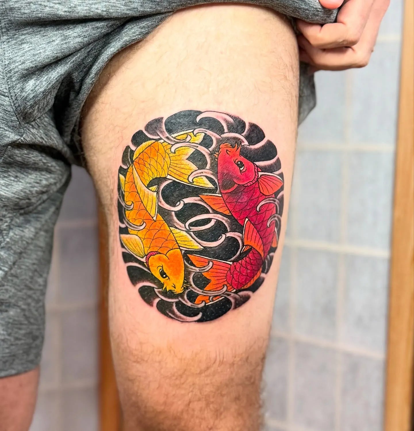japanese red and orange koi fish pair blackwork tattoo on man thigh