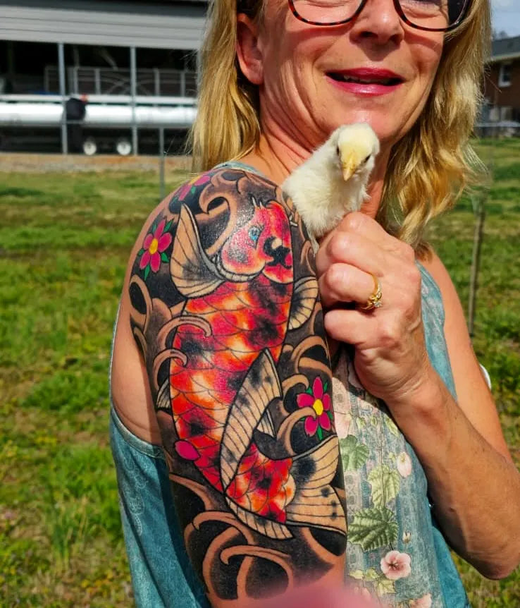 color half sleeve tattoo on woman shoulder and upper arm