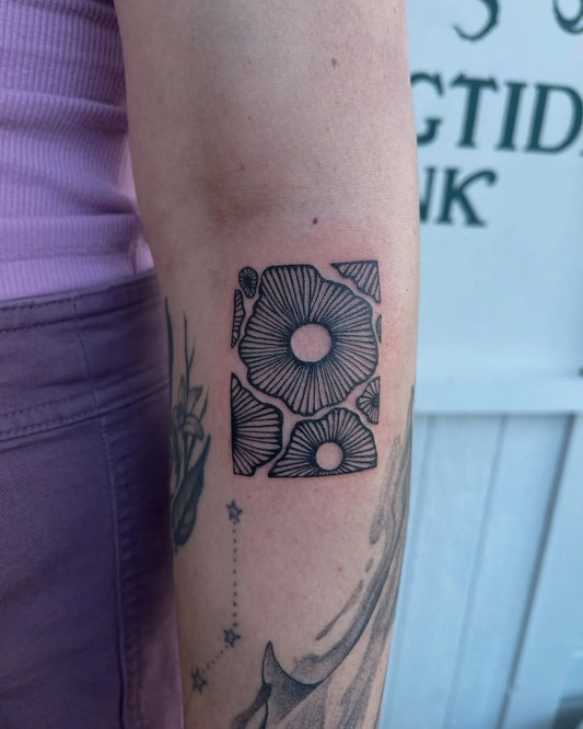 geometric flowers in square arm tattoo