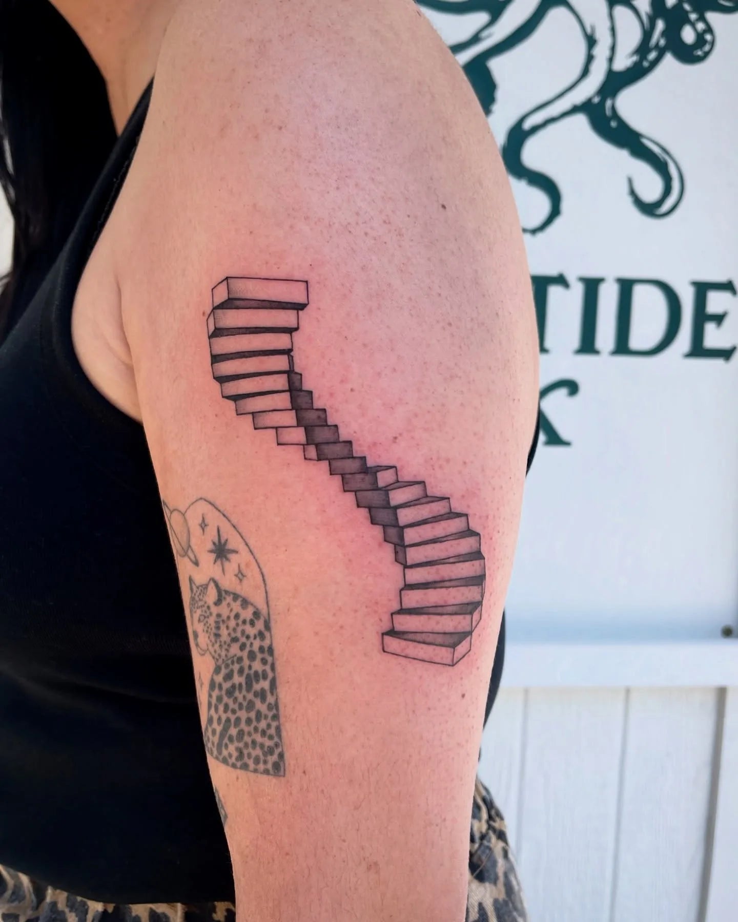 abstract black and grey staircase arm tattoo