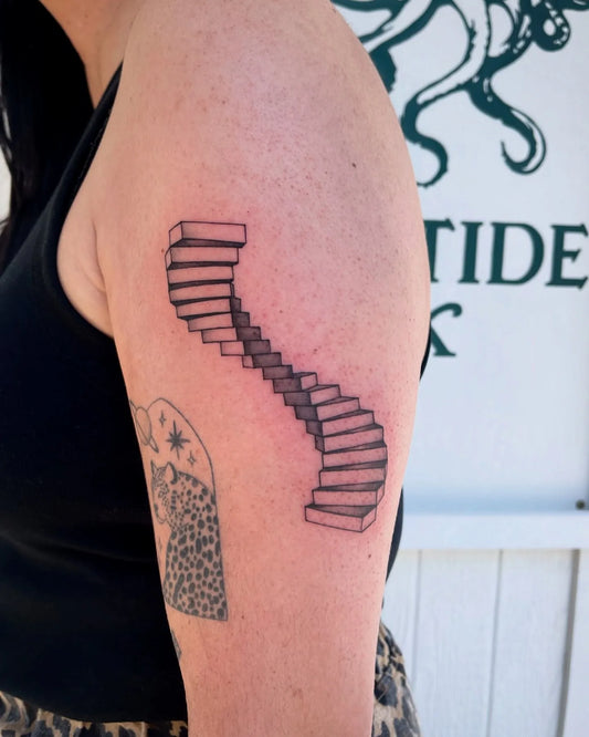 abstract black and grey staircase arm tattoo