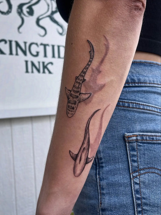 two sharks swimming with shadows forearm tattoos
