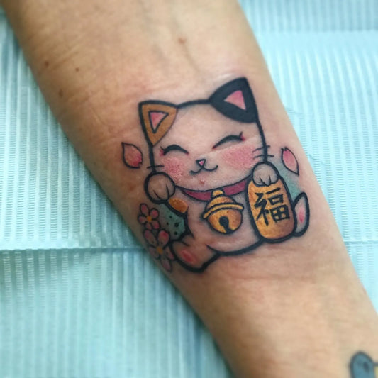 japanese lucky cat tattoo on forearm