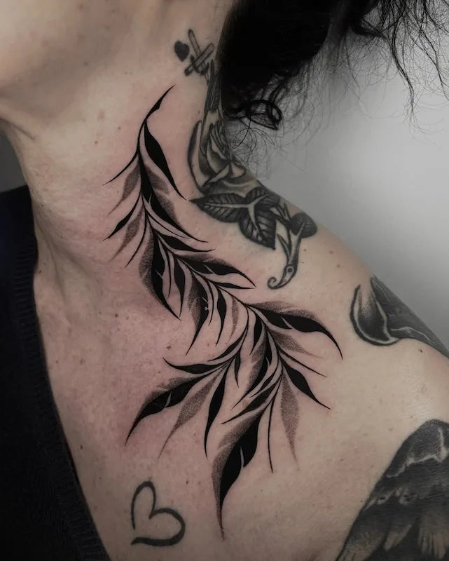 blackwork leaves tattoo on woman neck and shoulder