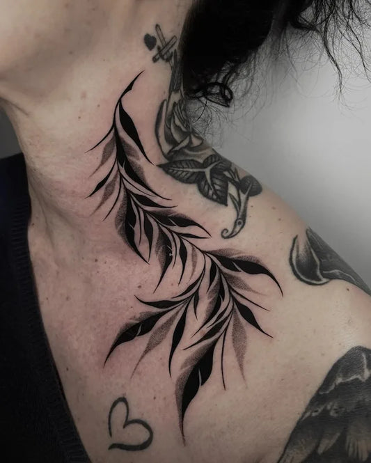 blackwork leaves tattoo on woman neck and shoulder