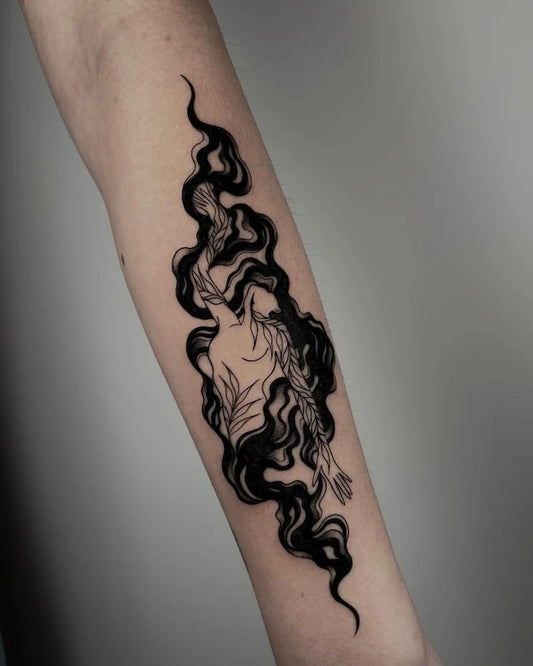 blackwork abstract woman figure smooke tattoo on forearm