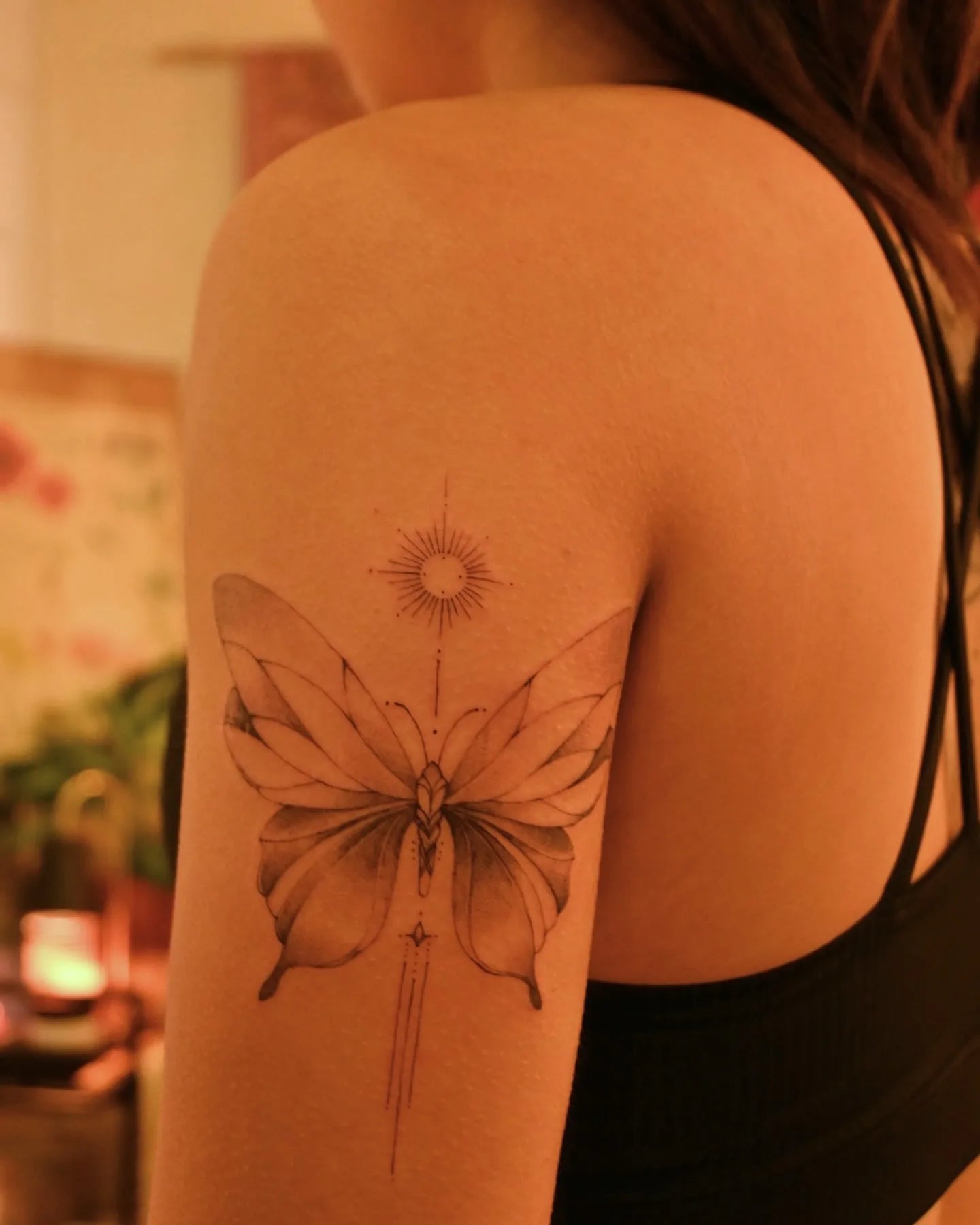 feminine ornamental butterfly upper arm tattoo 
