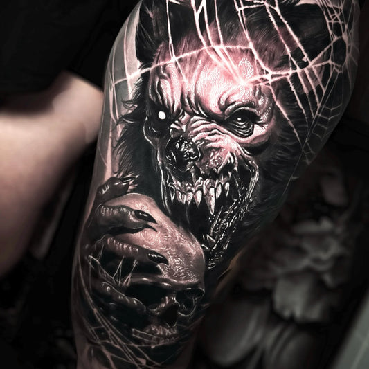 black and grey werewolf eating skull realism tattoo