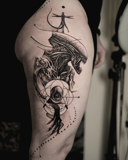 black and grey geometric alien realism tattoo on thigh