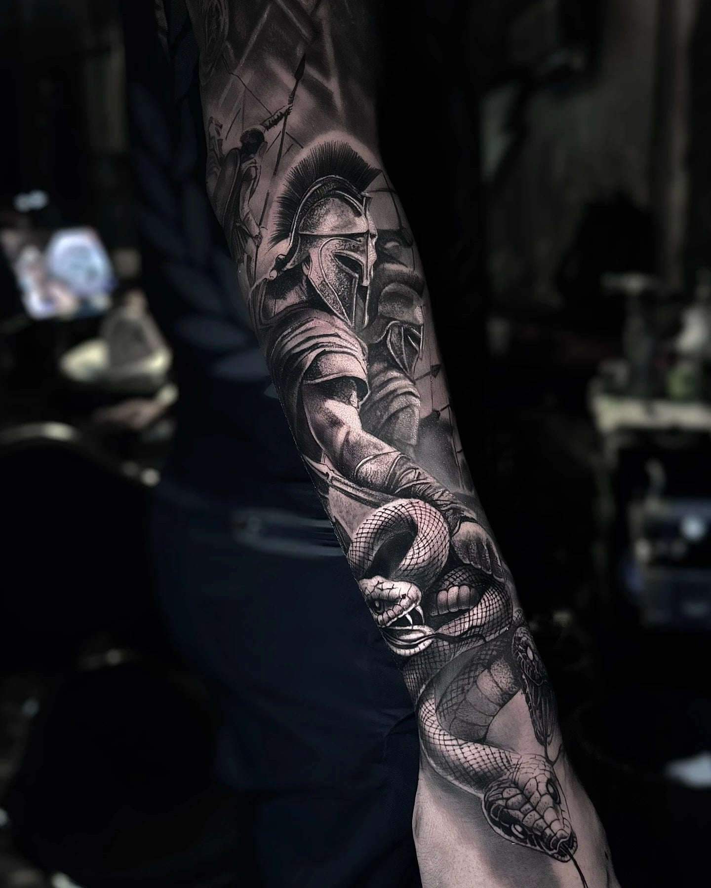 Spartan warrior with snake realism full arm sleeve tattoo black and grey
