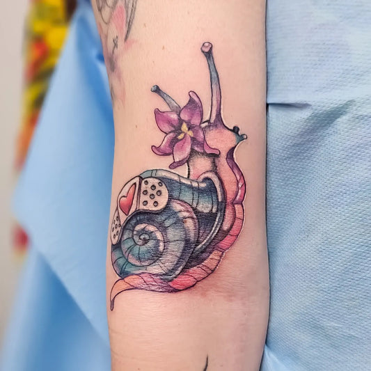 colorful cartoon snail arm tattoo