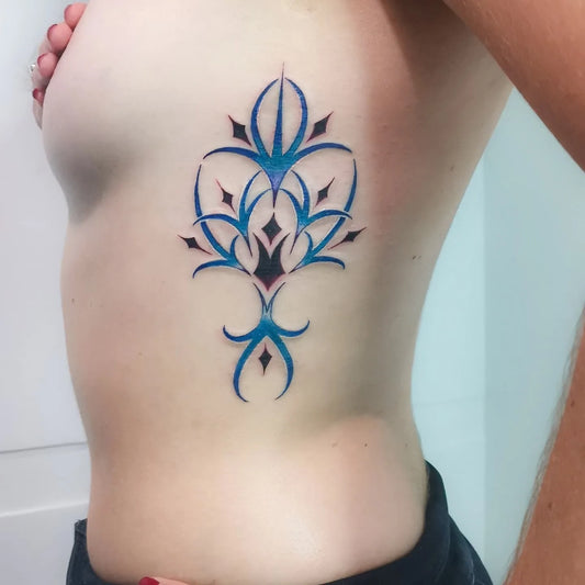 color abstract pattern woman rib tattoo