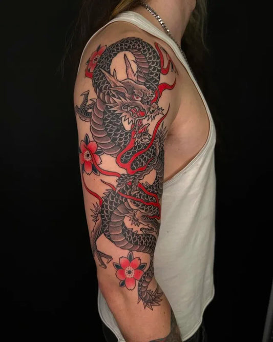 traditional japanese dragon tattoo with red accents on upper arm sleeve