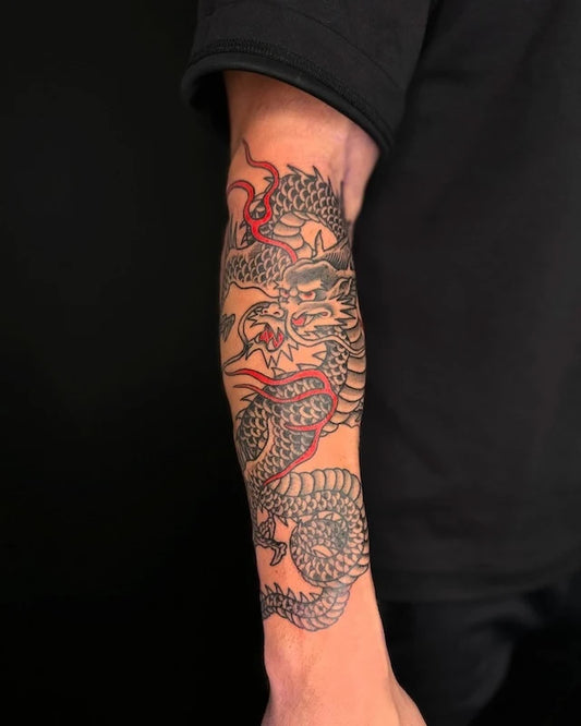 traditional dragon tattoo on man forearm