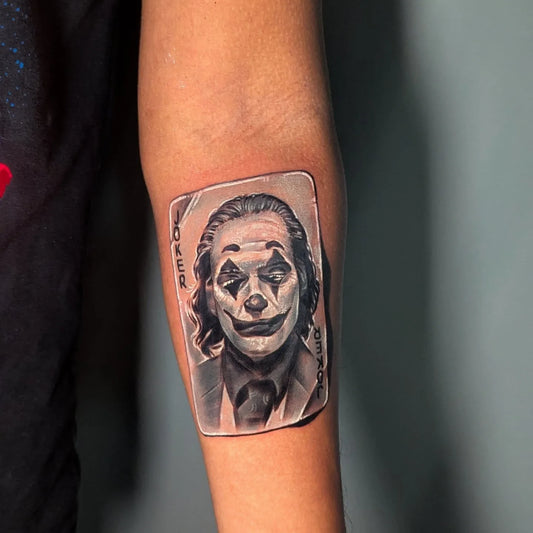 joker playing card white ink tattoo on forearm