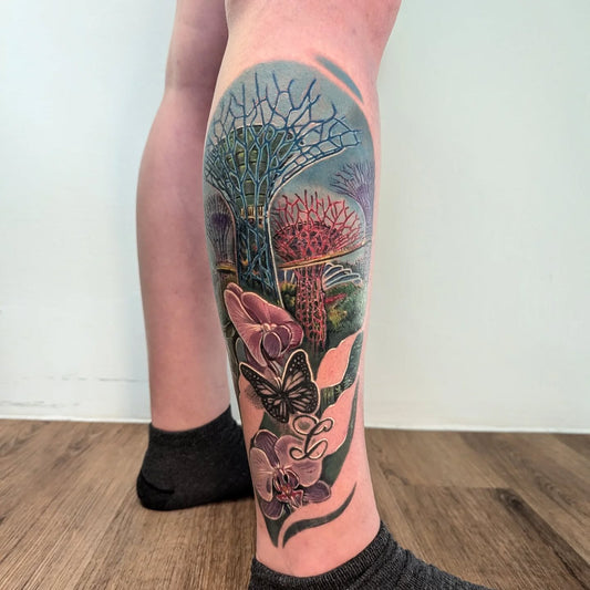 Singapore Gardens by the Bay landscape with floral butterflies color realism tattoo on calf leg
