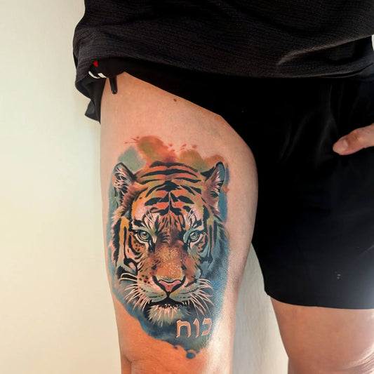 realistic watercolor tiger tattoo on thigh