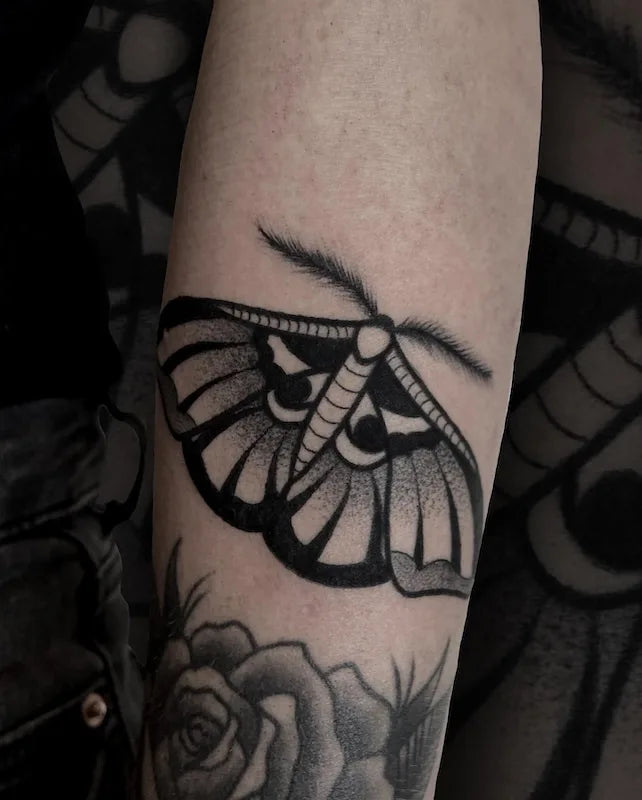 black and grey dotwork moth tattoo on arm
