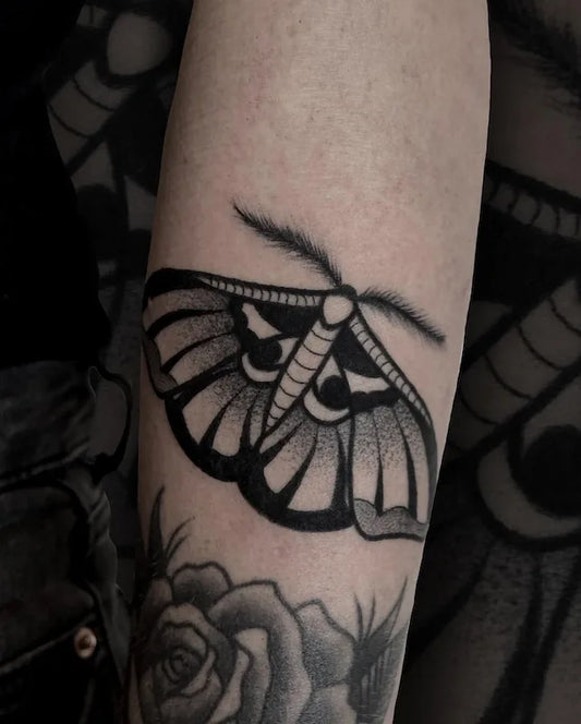 black and grey dotwork moth tattoo on arm